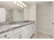Bathroom with white cabinetry, double sinks and granite countertops at 2203 Gopher Tortoise Ter, Oakland, FL 34787