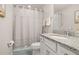 Clean bathroom featuring a granite countertop vanity, shower and tub combination, and tile floors at 2203 Gopher Tortoise Ter, Oakland, FL 34787