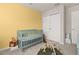 Well-lit Bedroom with a crib, closet, and play area offering a cozy environment at 2203 Gopher Tortoise Ter, Oakland, FL 34787