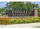 Elegant community sign 'Longleaf at Oakland' surrounded by vibrant landscaping at 2203 Gopher Tortoise Ter, Oakland, FL 34787