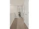 Bright hallway with wood-look flooring leads to a sunlit home office space at 2203 Gopher Tortoise Ter, Oakland, FL 34787