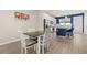 Open-concept kitchen and dining area with blue kitchen island and seating at 2203 Gopher Tortoise Ter, Oakland, FL 34787