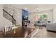 Bright and modern living room with open staircase, blue accent wall and cozy seating arrangement at 2203 Gopher Tortoise Ter, Oakland, FL 34787