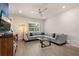 Spacious living room with large sectional sofa, flat-screen TV, and contemporary decor at 2203 Gopher Tortoise Ter, Oakland, FL 34787