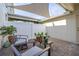 Enclosed brick patio area with shade sail and seating for two at 2203 Gopher Tortoise Ter, Oakland, FL 34787