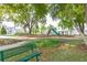 Community playground featuring a slide and swings, surrounded by lush trees and well-maintained landscaping at 2203 Gopher Tortoise Ter, Oakland, FL 34787