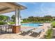 Community pool with lounge chairs, shaded seating, and manicured landscaping at 2203 Gopher Tortoise Ter, Oakland, FL 34787