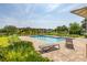 Community pool with pergola, lounge chairs, and manicured landscaping at 2203 Gopher Tortoise Ter, Oakland, FL 34787