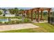 Community pool area with lounge chairs, picnic tables, and a pergola, perfect for relaxation and social gatherings at 2203 Gopher Tortoise Ter, Oakland, FL 34787