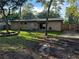 Large backyard with plenty of shade and privacy, featuring a wooden privacy fence at 225 W 2Nd St, Chuluota, FL 32766