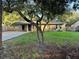 Charming single-story home with a covered parking and a large, mature tree in the front yard at 225 W 2Nd St, Chuluota, FL 32766