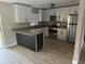 Updated kitchen featuring granite countertops, stainless steel appliances, and ample cabinet space at 225 W 2Nd St, Chuluota, FL 32766