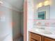Charming bathroom features tile shower with decorative accents and a vintage-style vanity with an oval sink at 2631 Mcdonald Ter, Mount Dora, FL 32757