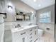 Bathroom with double vanity, marble countertops, and modern fixtures at 2631 Mcdonald Ter, Mount Dora, FL 32757