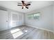 Bedroom with a closet, a ceiling fan, a window, light walls and light wood floors at 2631 Mcdonald Ter, Mount Dora, FL 32757