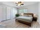 Cozy bedroom with a wooden bed frame, natural light, and dual closets at 2631 Mcdonald Ter, Mount Dora, FL 32757