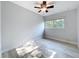 Empty bedroom with a ceiling fan, a window, light walls and light wood floors at 2631 Mcdonald Ter, Mount Dora, FL 32757
