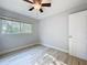 Empty bedroom with a ceiling fan, a window, light walls and light wood floors and closet at 2631 Mcdonald Ter, Mount Dora, FL 32757