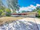 Charming single-story home featuring a brick accent wall, a well-manicured lawn, and an attached garage at 2631 Mcdonald Ter, Mount Dora, FL 32757