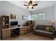 Bright home office features a ceiling fan, window and built-in desk with storage and shelving at 2631 Mcdonald Ter, Mount Dora, FL 32757