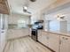 Updated kitchen featuring marble countertops, stainless steel appliances, and a breakfast bar at 2631 Mcdonald Ter, Mount Dora, FL 32757