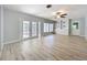 Bright living room with hardwood floors, French doors, and built-in shelves at 2631 Mcdonald Ter, Mount Dora, FL 32757