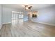 Open-concept living room boasting hardwood floors, fresh paint, and seamless flow to the kitchen and backyard at 2631 Mcdonald Ter, Mount Dora, FL 32757