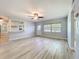 Well-lit living room featuring hardwood floors, fresh paint, and abundant natural light from the front window at 2631 Mcdonald Ter, Mount Dora, FL 32757