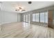 Bright living room with hardwood floors, ceiling fan, and sliding doors to the patio at 2631 Mcdonald Ter, Mount Dora, FL 32757