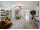 Spacious living room featuring hardwood floors, an adjacent kitchen, and a clear view of the backyard at 2631 Mcdonald Ter, Mount Dora, FL 32757