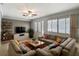 Spacious living room featuring a large sectional sofa, mounted TV, and hardwood floors at 2631 Mcdonald Ter, Mount Dora, FL 32757
