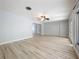 Large living room with hardwood floors, ceiling fan, and adjacent hallway to other rooms at 2631 Mcdonald Ter, Mount Dora, FL 32757
