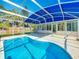 Inviting pool area features a covered bar, outdoor lounging space, and a clear blue pool at 2631 Mcdonald Ter, Mount Dora, FL 32757