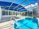 Enclosed pool area featuring a clear blue pool with a spacious outdoor patio, offering relaxation and enjoyment at 2631 Mcdonald Ter, Mount Dora, FL 32757