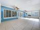 Bright sunroom features a calming blue accent wall, ceiling fans, and ample windows offering plenty of natural light at 2631 Mcdonald Ter, Mount Dora, FL 32757
