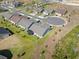 Aerial view of the neighborhood, showing well-maintained lawns, screened lanais, and mature landscaping at 2681 Spider Lily Ct, Clermont, FL 34711