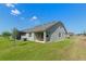 Spacious backyard with lush grass, a screened lanai, and an extended covered patio for outdoor enjoyment at 2681 Spider Lily Ct, Clermont, FL 34711