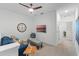 The bonus room offers a comfortable seating area, modern ceiling fan, and a view to another room at 2681 Spider Lily Ct, Clermont, FL 34711