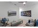 The bonus room offers comfortable seating, neutral carpet, and a mounted television for entertainment at 2681 Spider Lily Ct, Clermont, FL 34711