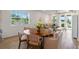 Cozy dining room featuring wood-style flooring and a large window with natural light at 2681 Spider Lily Ct, Clermont, FL 34711