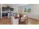 Kitchen and dining area featuring modern cabinetry, stainless appliances and a large kitchen island at 2681 Spider Lily Ct, Clermont, FL 34711