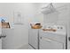 The laundry room is equipped with modern washer and dryer, wire shelving, and ample storage space at 2681 Spider Lily Ct, Clermont, FL 34711