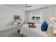 Well-lit primary bedroom with a decorative tray, comfortable seating, and a view from the window at 2681 Spider Lily Ct, Clermont, FL 34711