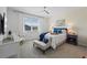 Serene bedroom with a comfortable bed, stylish furniture, soft lighting, and a large window at 2681 Spider Lily Ct, Clermont, FL 34711