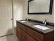 Bathroom with dual sink vanity with wood cabinets and granite countertops at 2886 Carew Ave, Winter Park, FL 32789