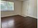 Bright bedroom with large window and wood flooring throughout the space at 2886 Carew Ave, Winter Park, FL 32789