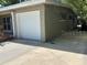 Exterior view of home featuring a garage and ample parking space on a concrete driveway at 2886 Carew Ave, Winter Park, FL 32789
