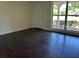 Bright living room with dark floors, showcasing a large window offering ample natural light and airy feel at 2886 Carew Ave, Winter Park, FL 32789