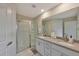 Bright bathroom featuring a glass-enclosed shower and double vanity with modern fixtures at 2956 Oak Park Way # B, Orlando, FL 32822