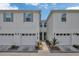 Well maintained townhouse with white exterior, teal shutters, and a one car garage at 2956 Oak Park Way # B, Orlando, FL 32822
